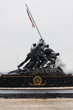 black and red statue of man holding flag