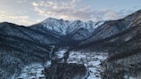 Snow-capped mountains towering above a quiet alpine village.