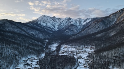 Snow-capped mountains towering above a quiet alpine village.