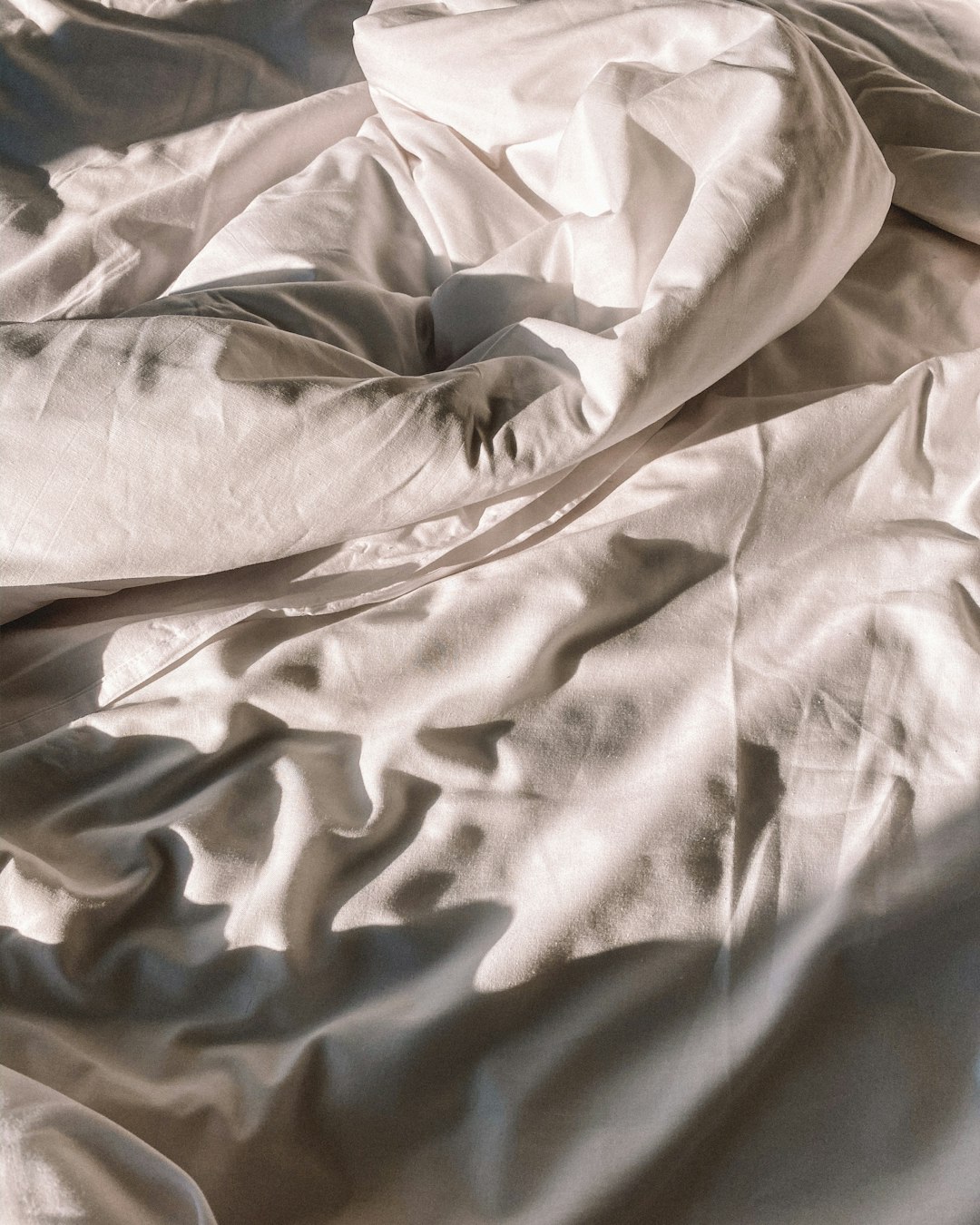  gray textile on white textile blanket