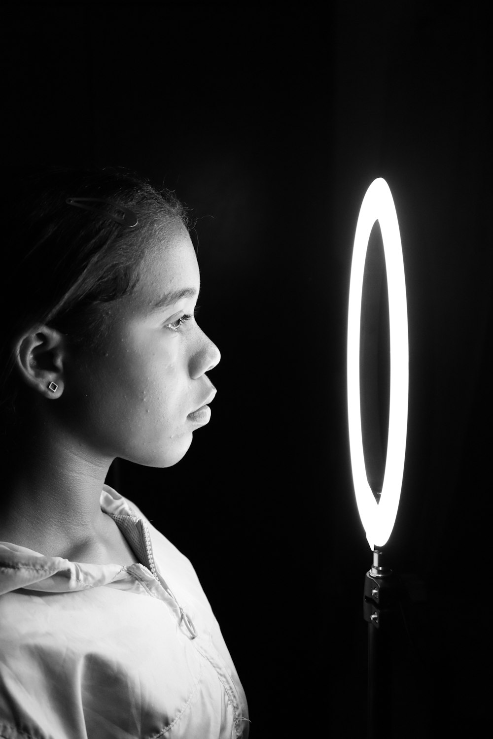 woman in white collared shirt holding lighted candle