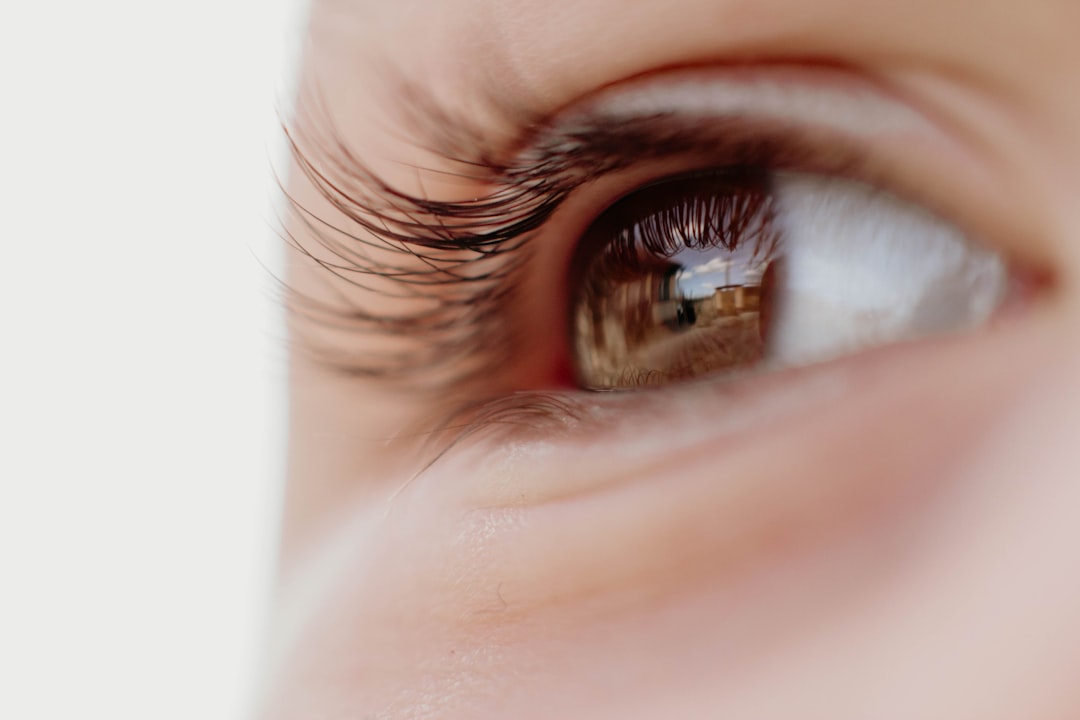 persons brown eyes in close up photography