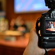 person holding black dslr camera