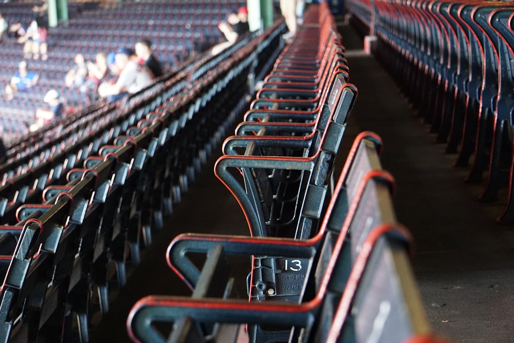 people sitting on red gang chairs