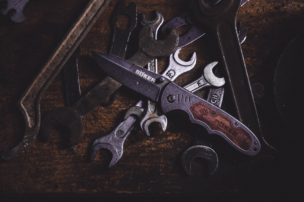 black and silver scissors on brown wooden table