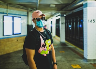 woman in black crew neck t-shirt wearing white cap and sunglasses