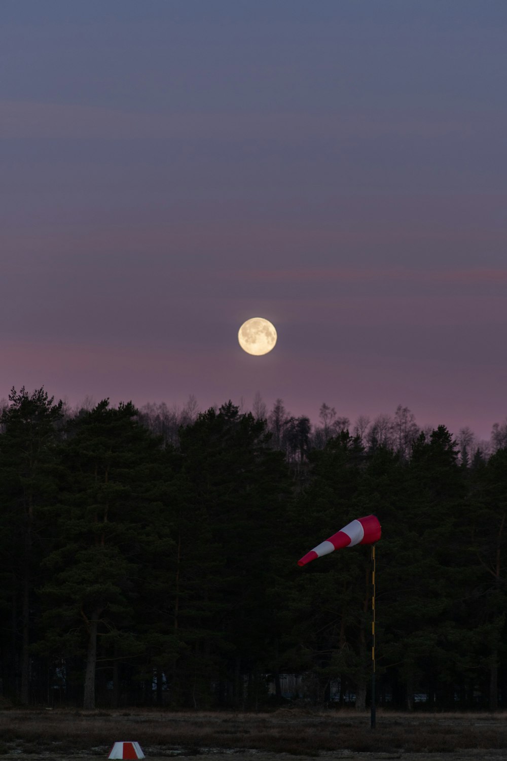 red and white flag on pole during night time