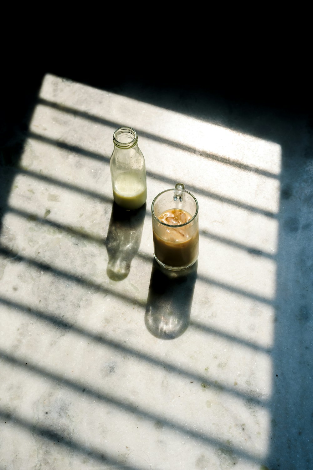 clear glass bottle with brown liquid