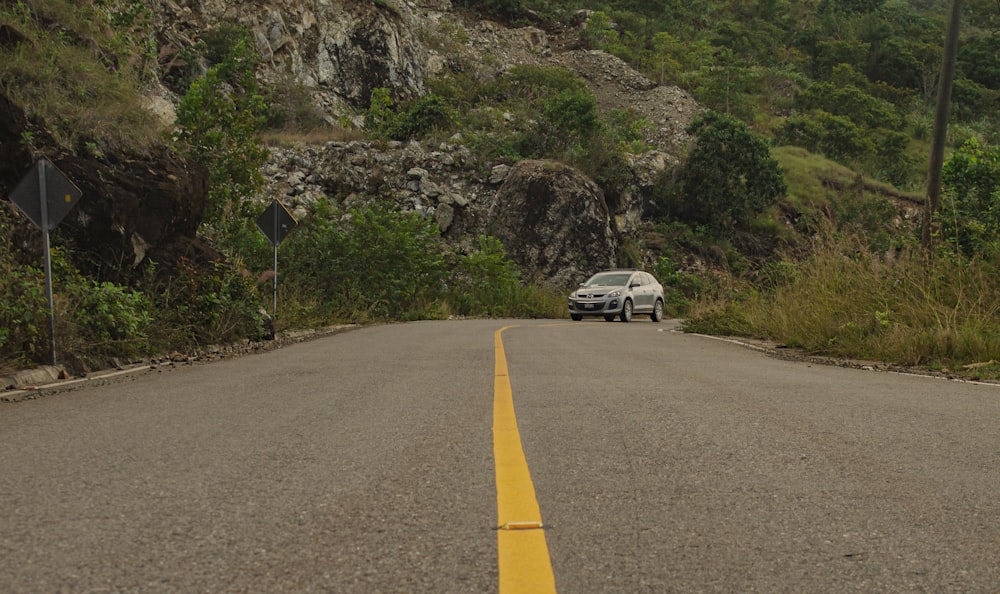 white suv on road near mountain during daytime