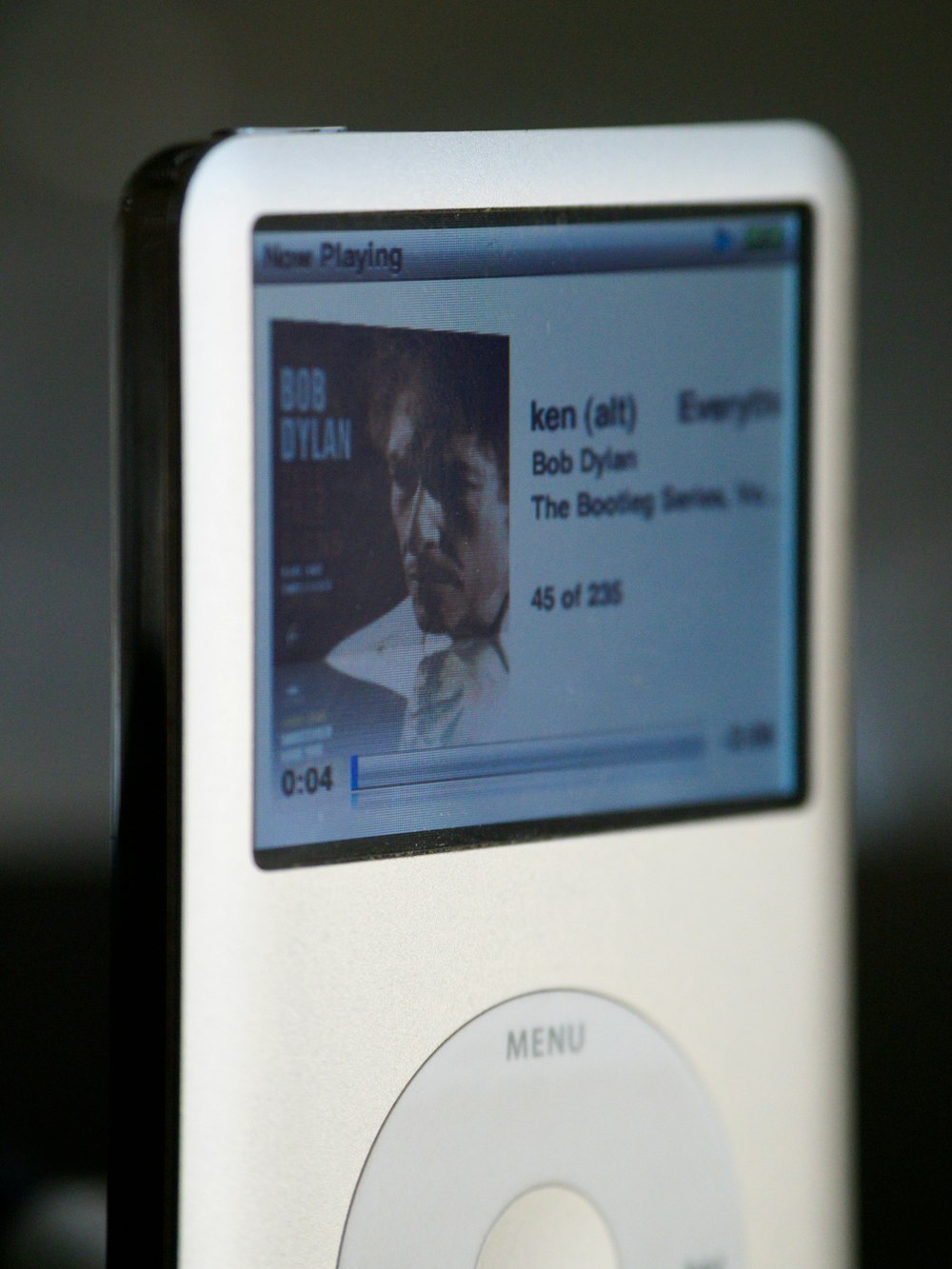 white ipod classic showing man in black jacket