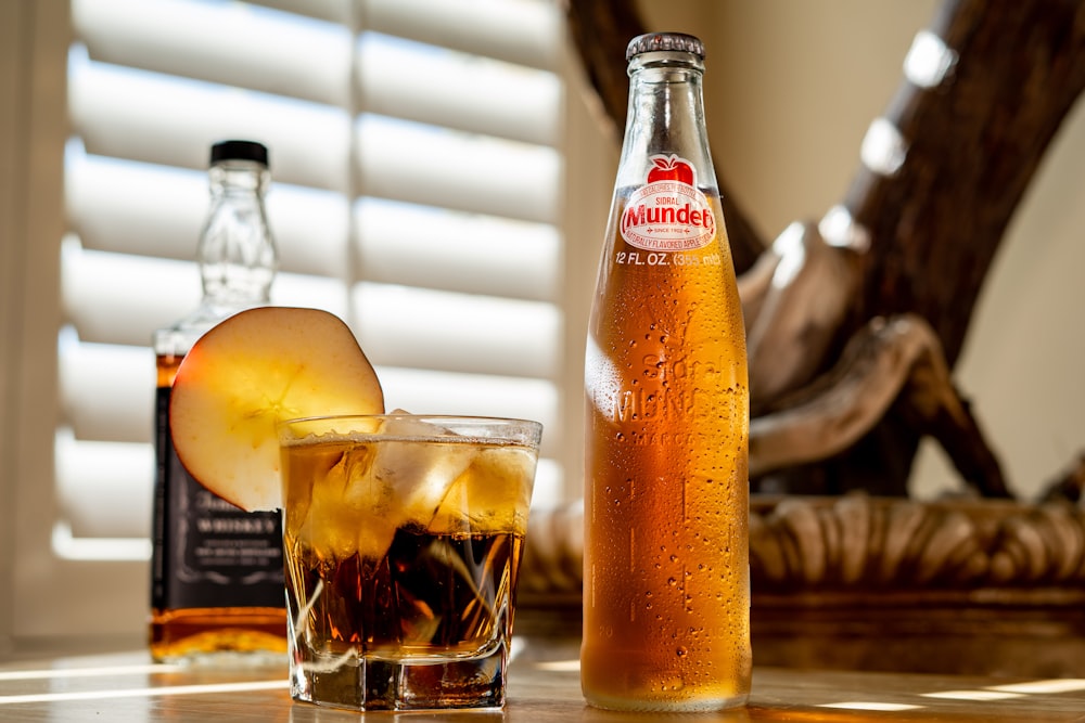 clear glass bottle with brown liquid