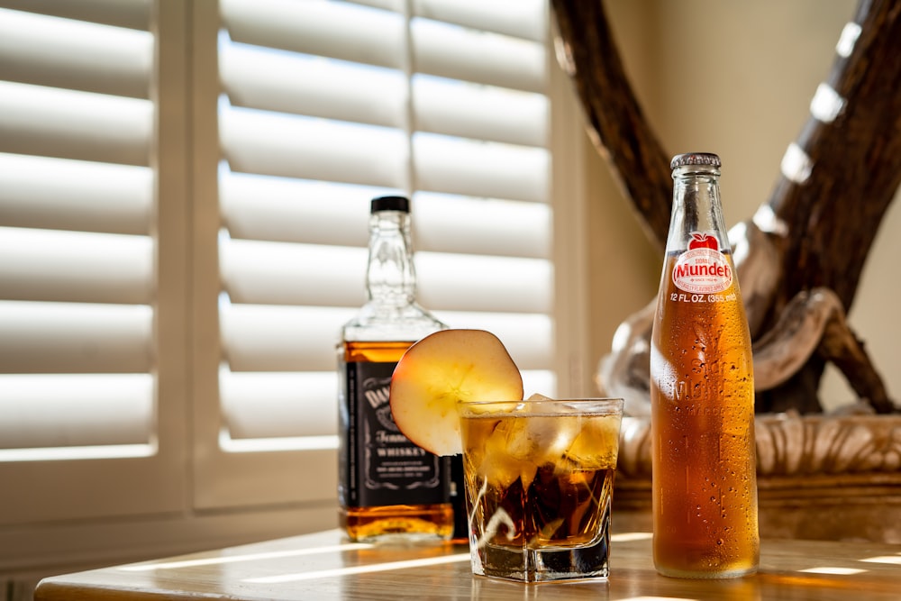 clear glass bottle with orange liquid