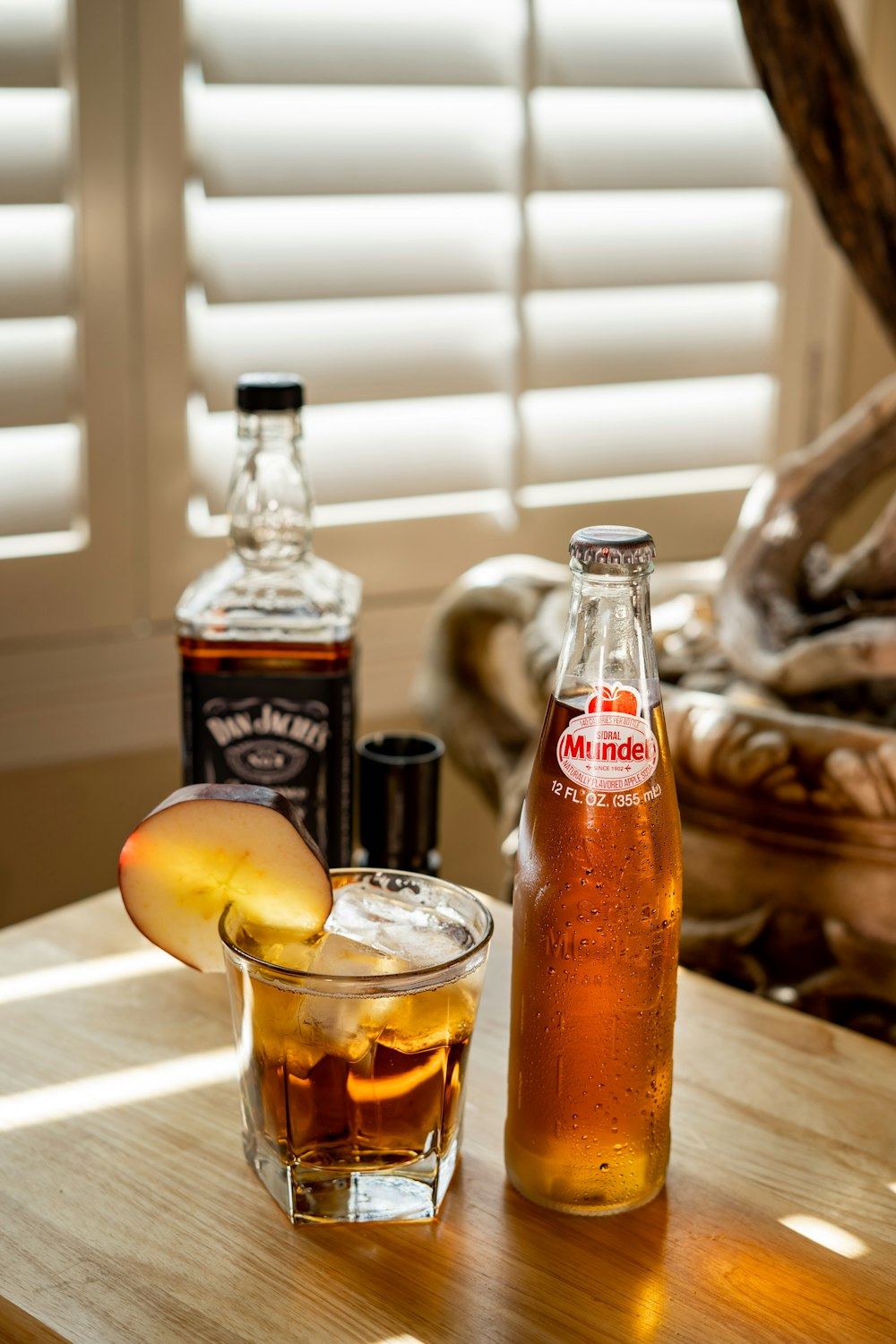 clear glass bottle beside clear drinking glass