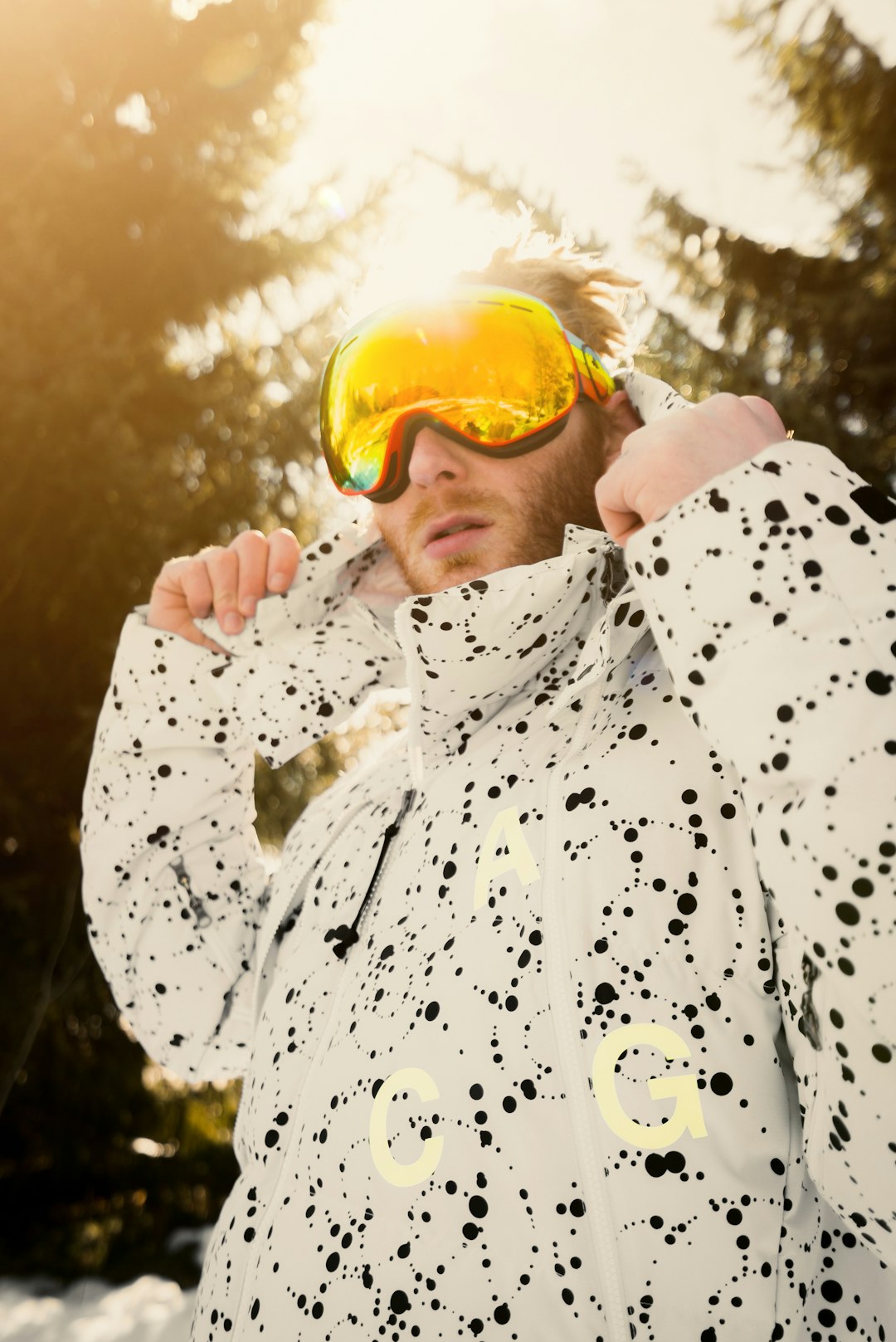 man in white and black floral dress shirt wearing yellow goggles