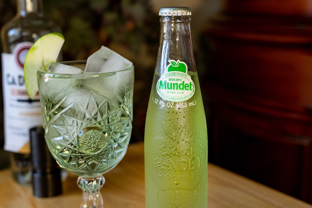 clear glass bottle with green liquid