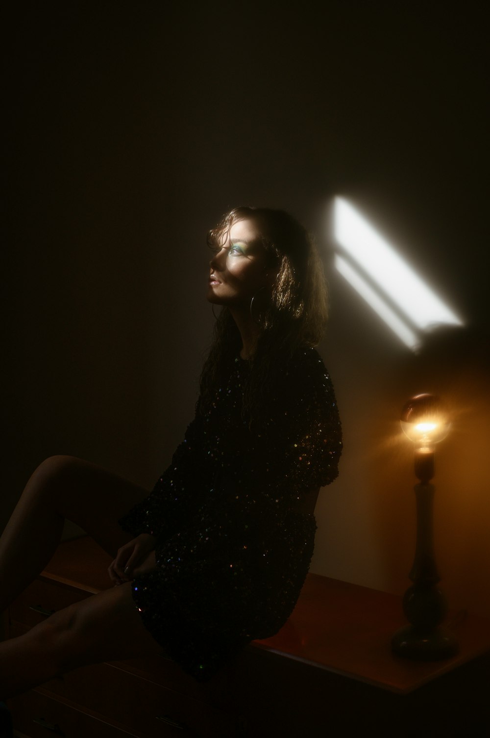 woman in black dress sitting on chair