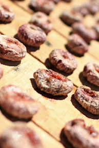 Close-up of ripe figs drying naturally on traditional woven mats.