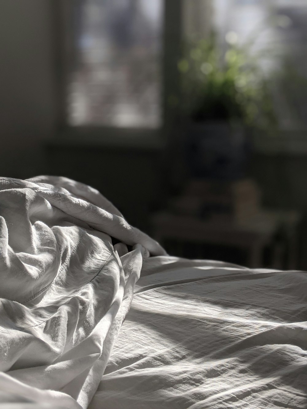 white textile on brown wooden bed frame