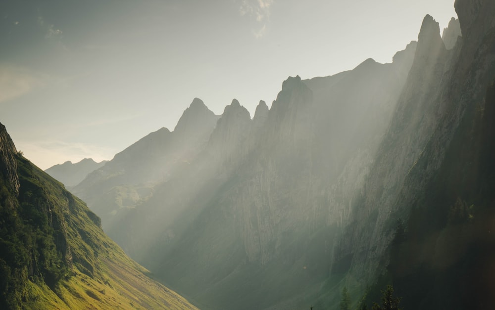 green and brown mountains under white clouds during daytime