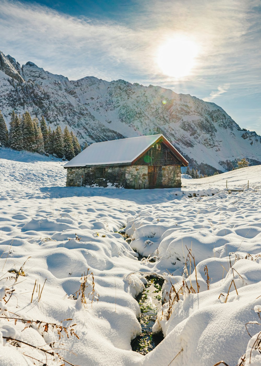 brown wooden house on snow covered ground