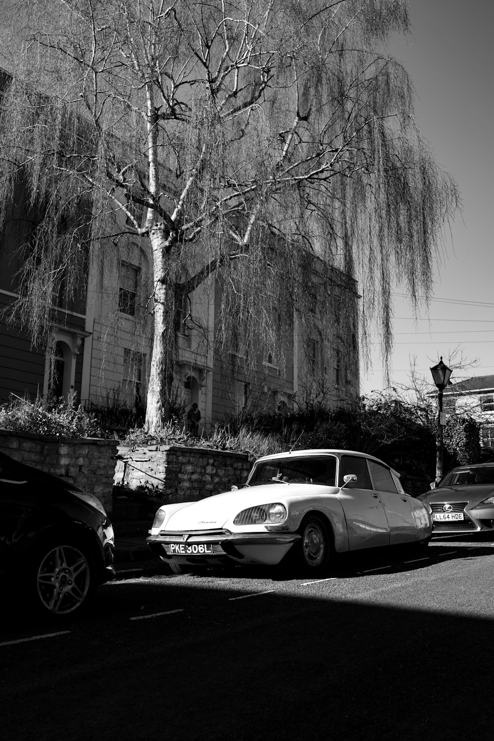 white sedan parked beside black car