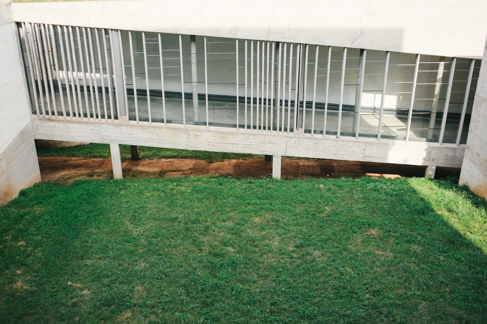 white metal fence on green grass field