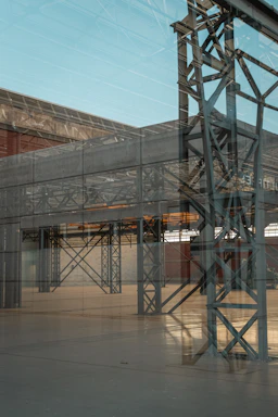 Close-up of shiny stainless steel sheets reflecting light in a modern warehouse.