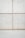 A concrete wall with a grid pattern is formed by the intersection of vertical and horizontal seams. The surface is smooth with visible small, round indentations evenly distributed across the panels. The lower section of the image shows a plain concrete floor.
