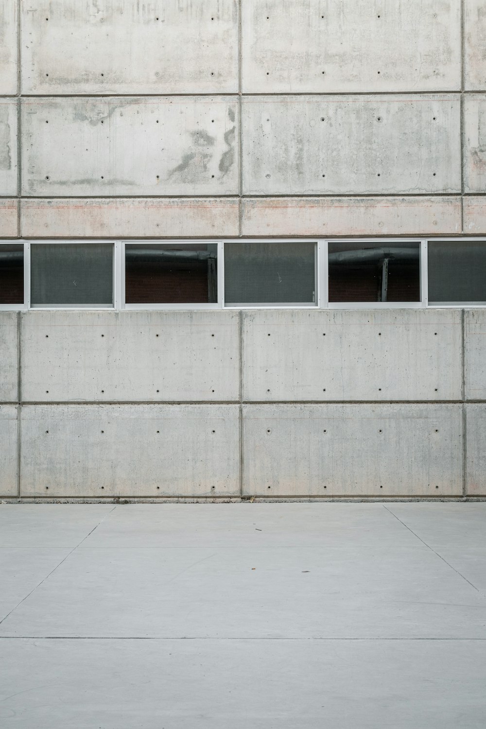 white concrete building with glass windows