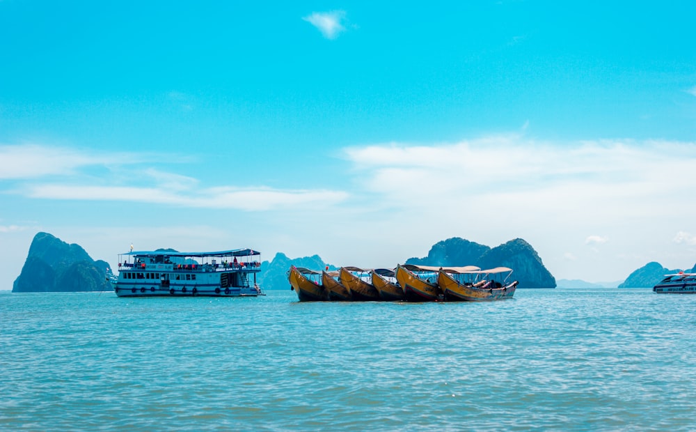 brown boat on sea under blue sky during daytime