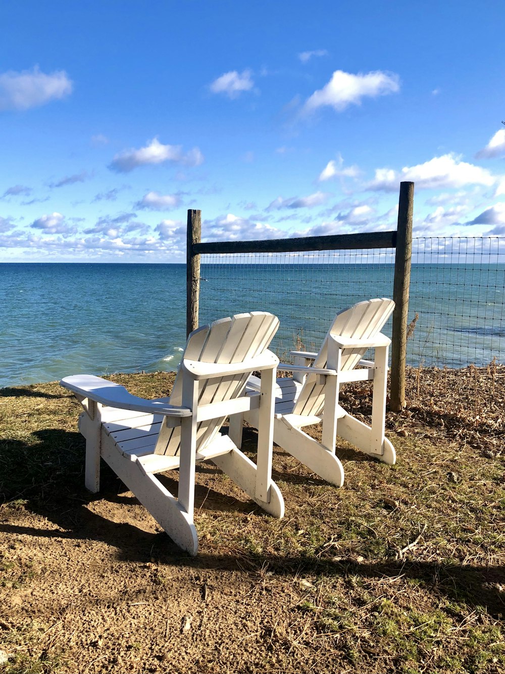 white wooden armchair on beach shore during daytime