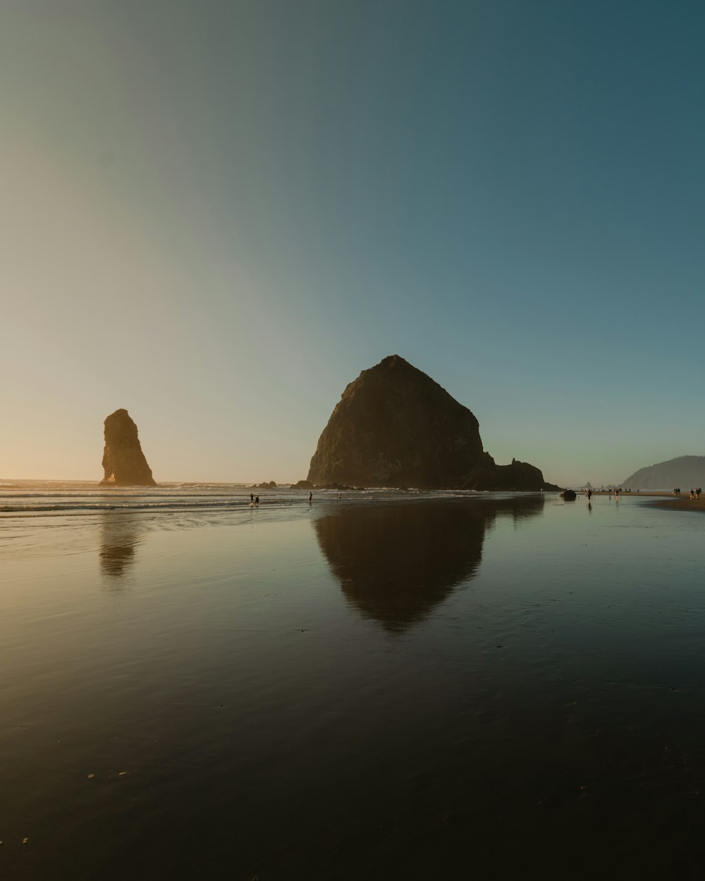 brown rock formation on body of water during daytime