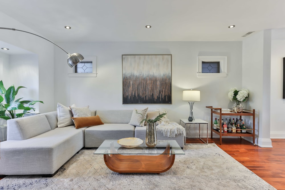 brown wooden oval table near white couch