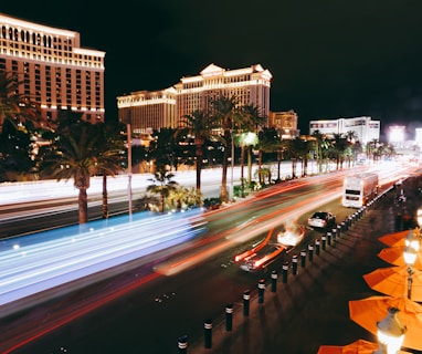 cars on road near high rise building during night time