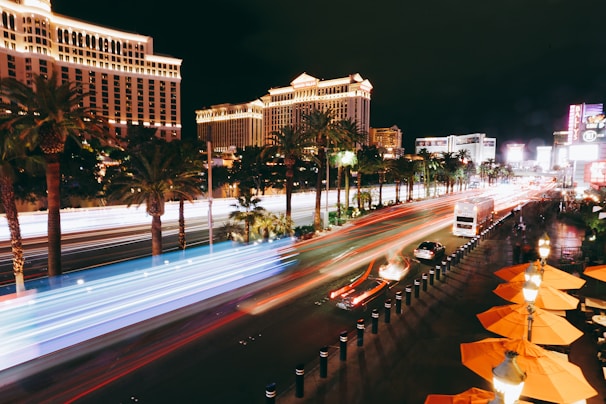 cars on road near high rise building during night time