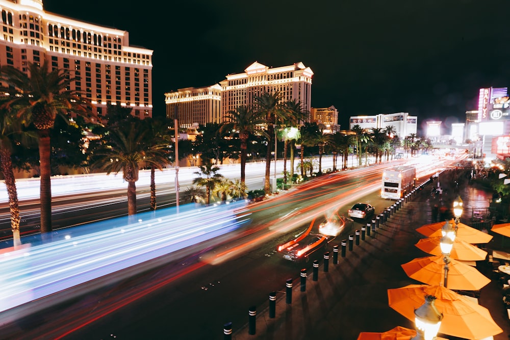 cars on road near high rise building during night time