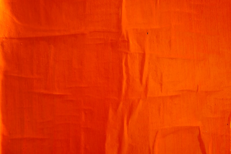 orange textile on white textile