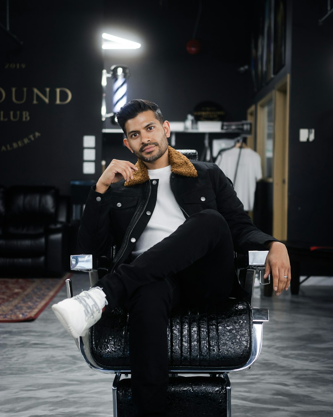 man in black suit sitting on black chair