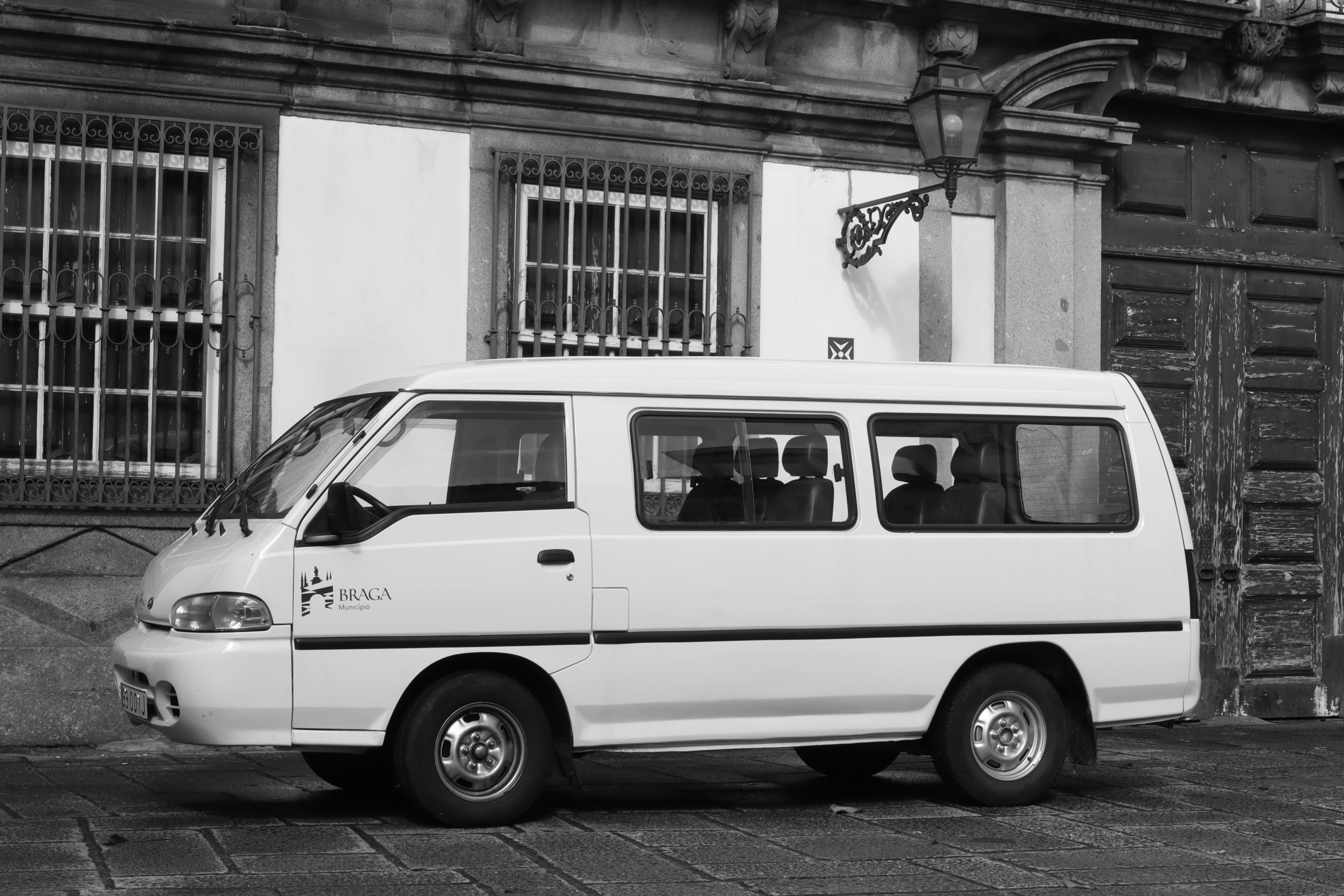 white van parked beside building