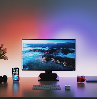 black flat screen computer monitor on brown wooden desk