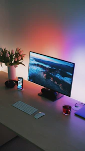 black flat screen computer monitor beside black and gray remote control