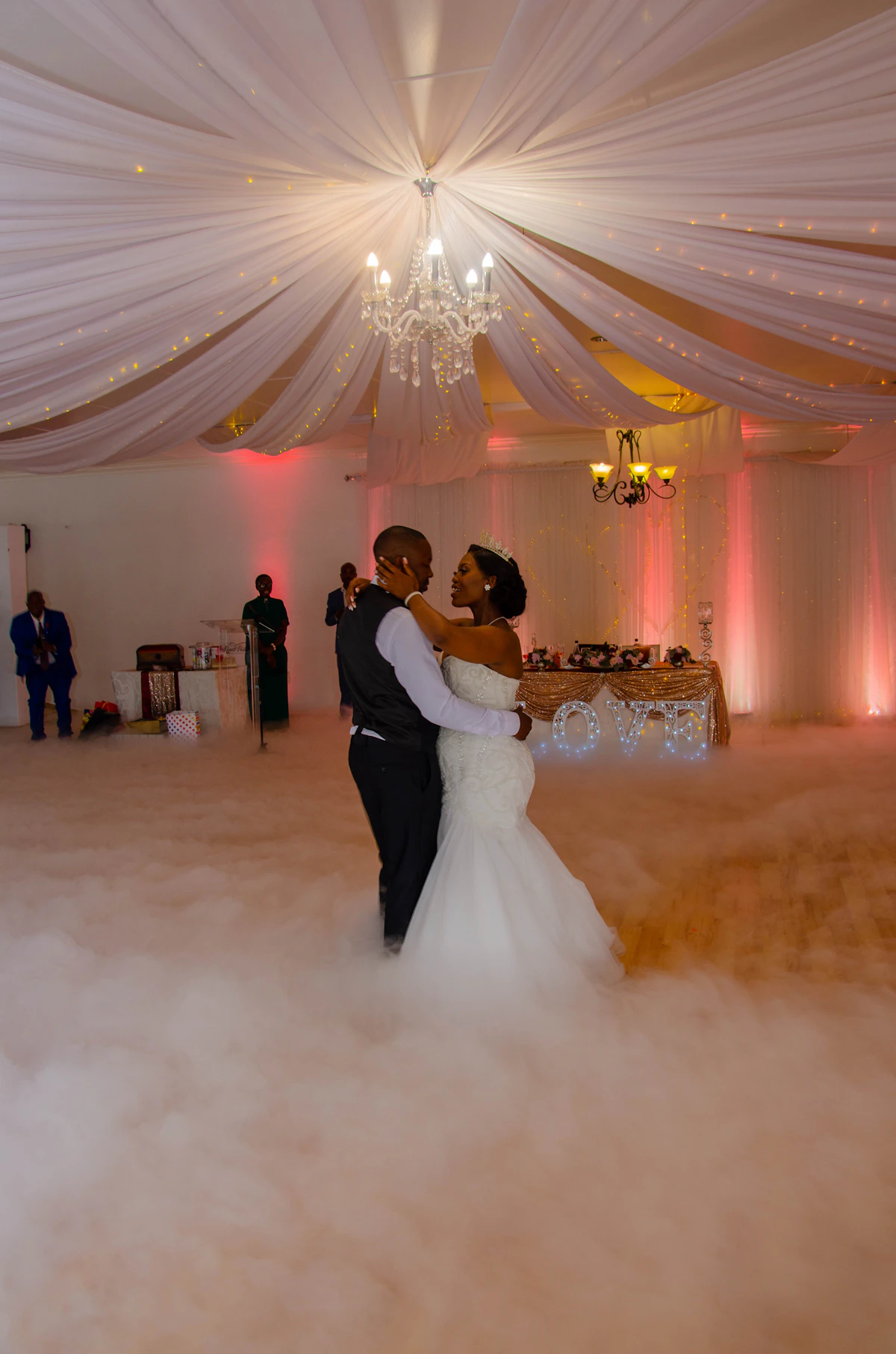 Bride and groom dancing on a colorful wedding stage