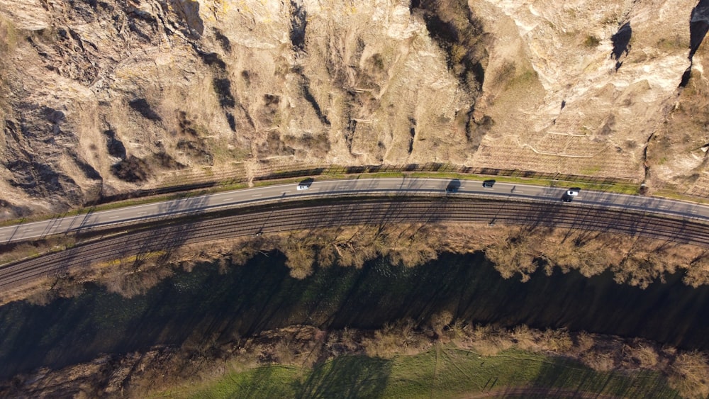 aerial view of road in between of rocky mountains during daytime