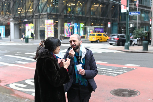 A friendly outreach representative engaging in a warm conversation with a passerby on a busy Toronto street.