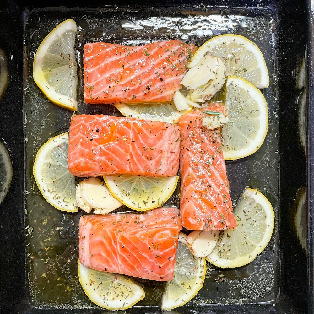 sliced fish meat on black plate