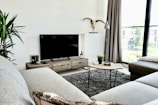 black flat screen tv on brown wooden tv rack