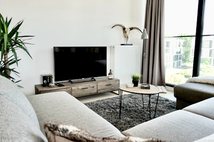black flat screen tv on brown wooden tv rack