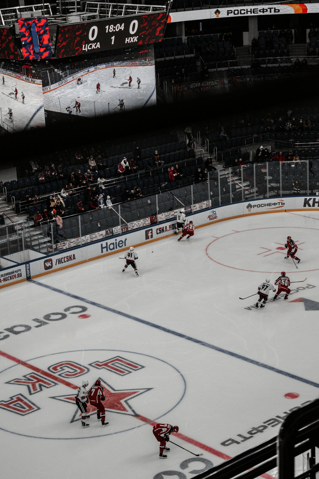 people playing ice hockey inside stadium