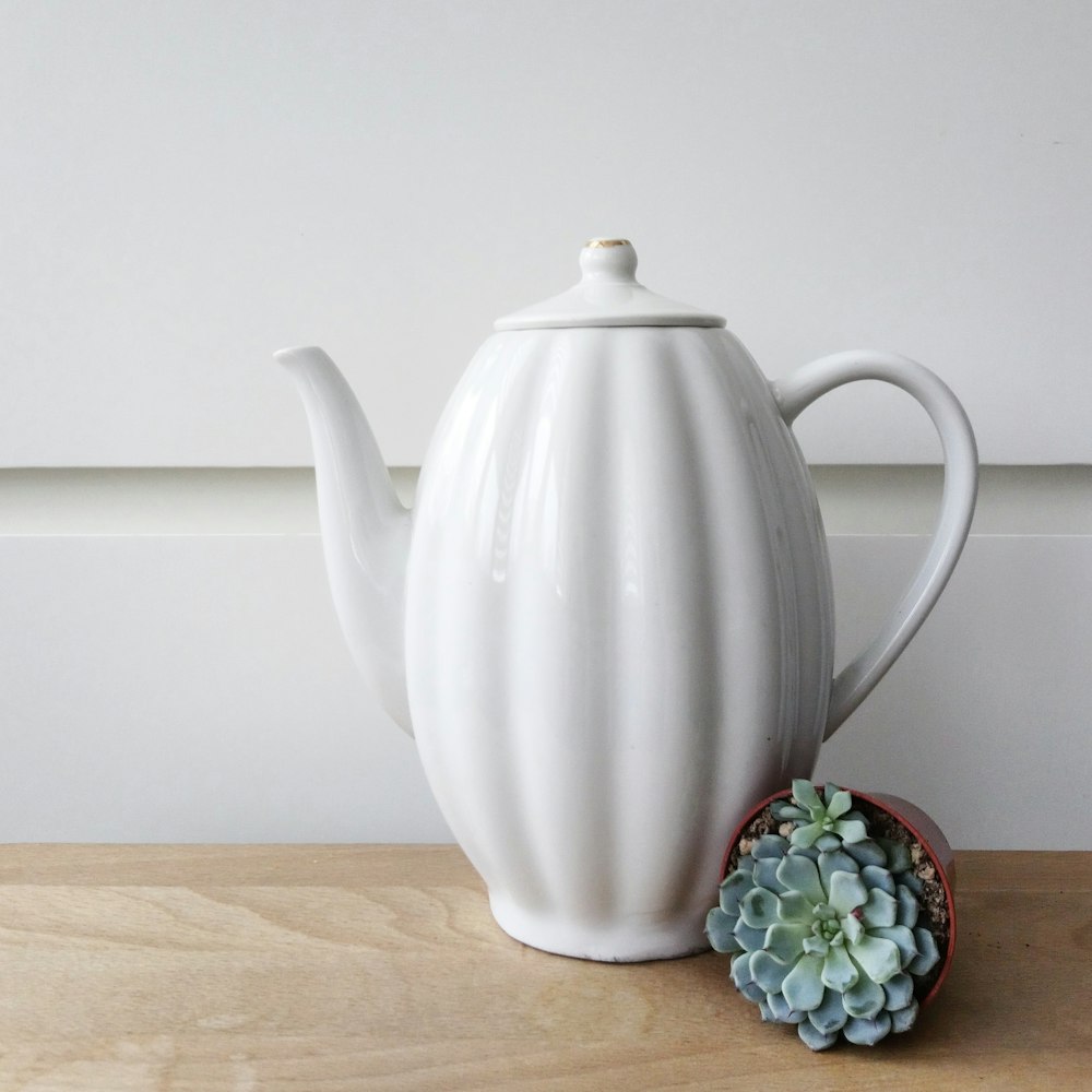 black and white ceramic teapot on brown wooden table