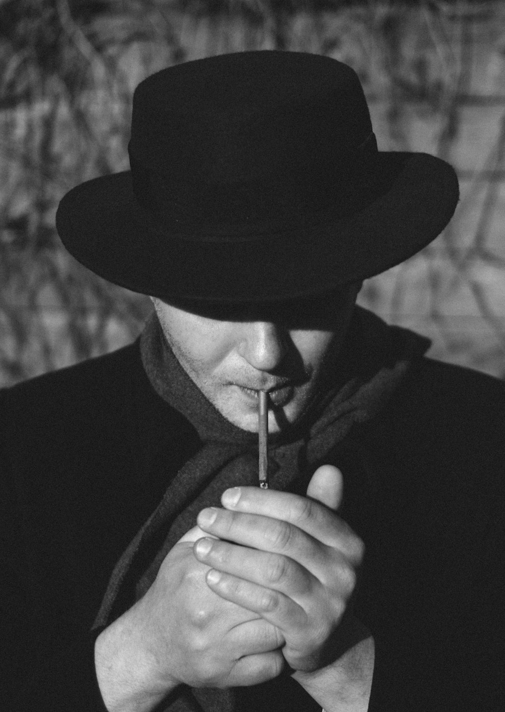 man in black hat smoking cigarette